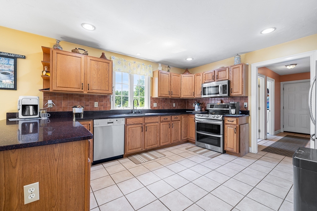 898 Main Street West Wareham, MA 02576 - Photo 7 of 36 a kitchen with stainless steel appliances granite countertop a stove top oven a sink dishwasher and a refrigerator