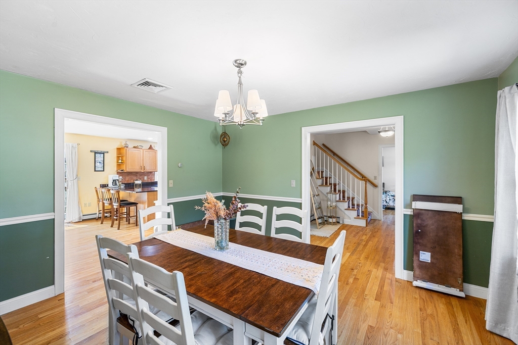 898 Main Street West Wareham, MA 02576 - Photo 10 of 36 a view of a dining room with furniture a chandelier and wooden floor