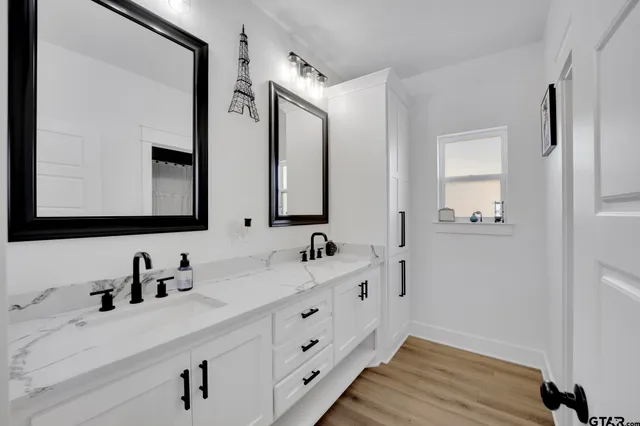 a bathroom with a double vanity sink and mirror