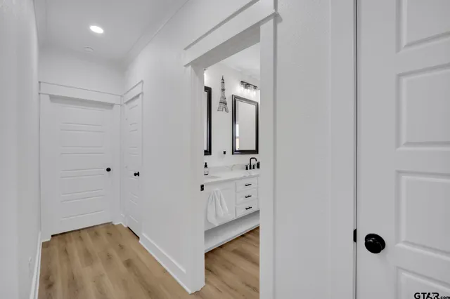 a bedroom with a bed a flat screen tv and dresser