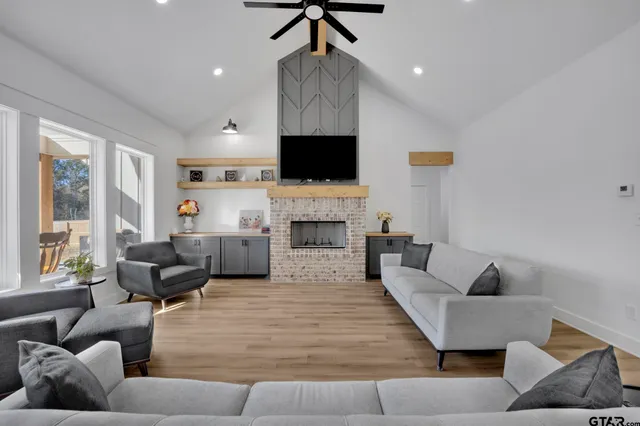 a living room with furniture fireplace and a flat screen tv