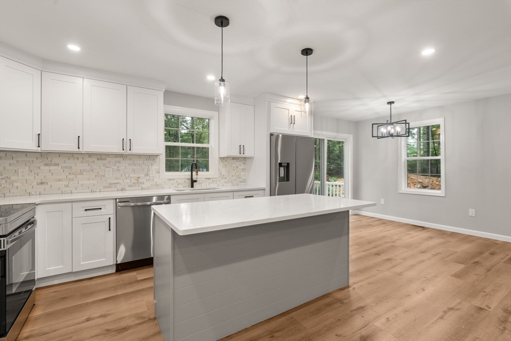 75 Hiland Road Charlton, MA 01507 - Photo 11 of 38 a kitchen with a sink stove and cabinets