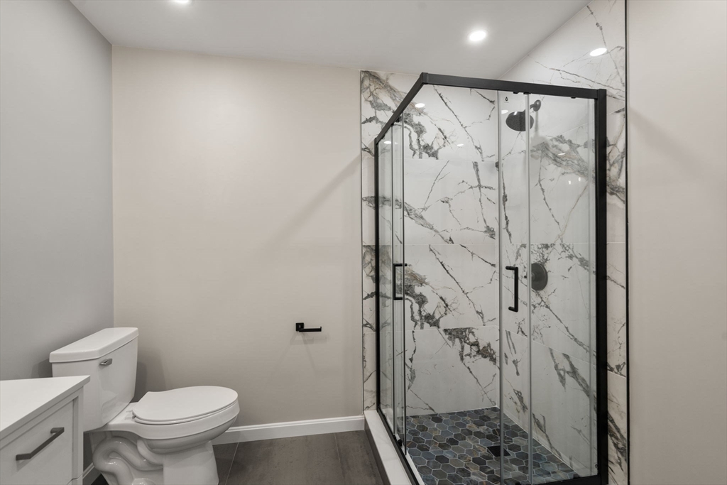 75 Hiland Road Charlton, MA 01507 - Photo 13 of 38 a bathroom with a granite countertop shower and a toilet