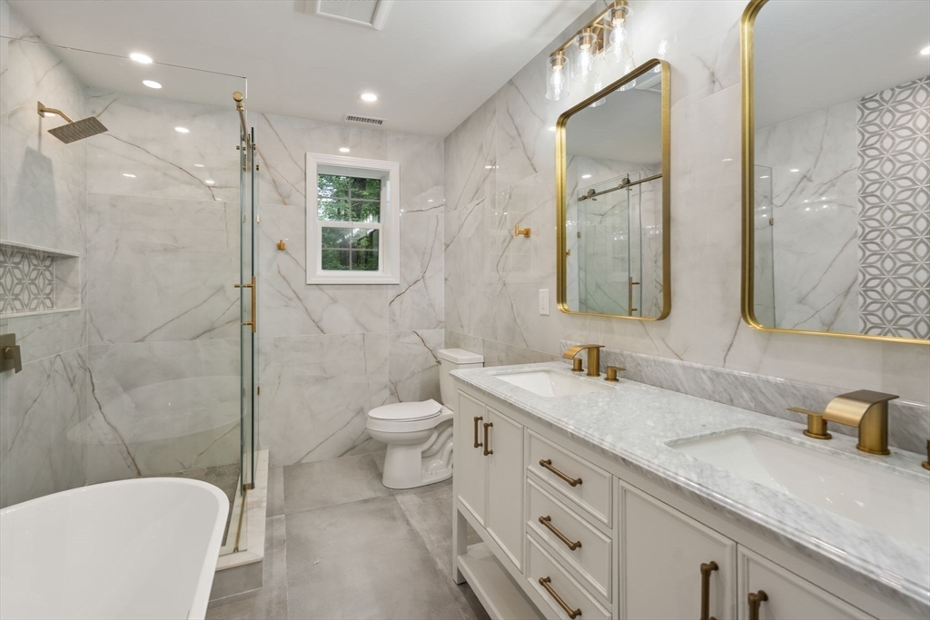 75 Hiland Road Charlton, MA 01507 - Photo 20 of 38 a bathroom with a granite countertop sink mirror vanity and toilet