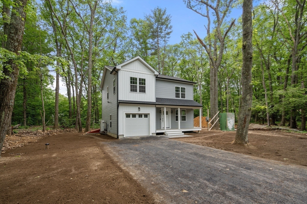 75 Hiland Road Charlton, MA 01507 - Photo 35 of 38 a front view of a house with a garden