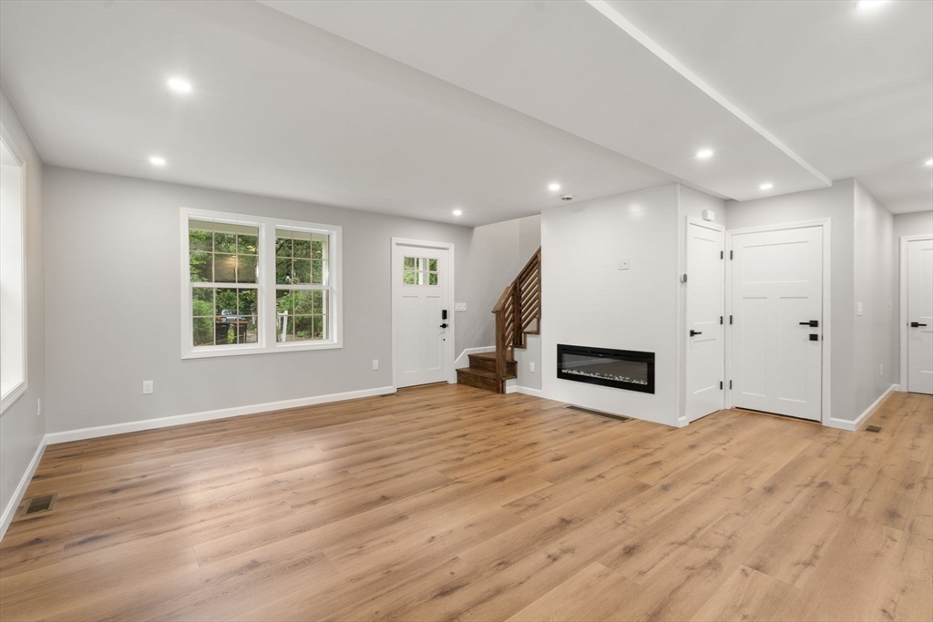 75 Hiland Road Charlton, MA 01507 - Photo 4 of 38 a view of an empty room with a window and wooden floor