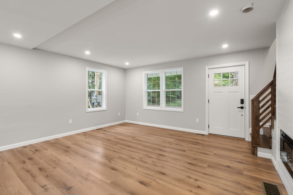75 Hiland Road Charlton, MA 01507 - Photo 6 of 38 an empty room with wooden floor and a window