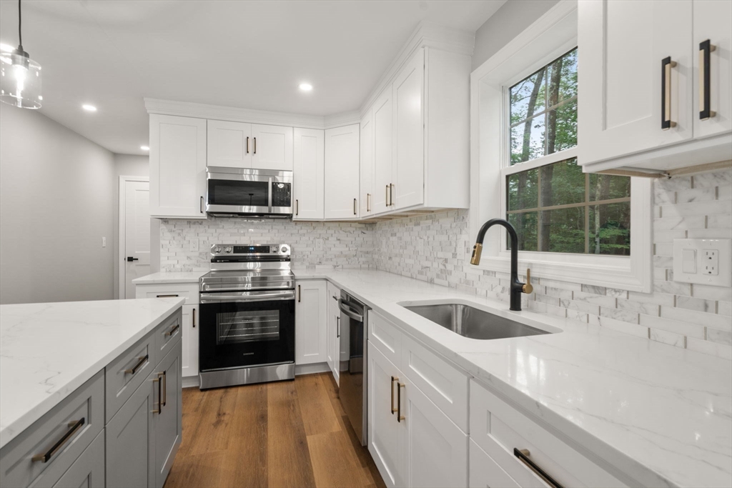 75 Hiland Road Charlton, MA 01507 - Photo 9 of 38 a kitchen with sink a stove and cabinets