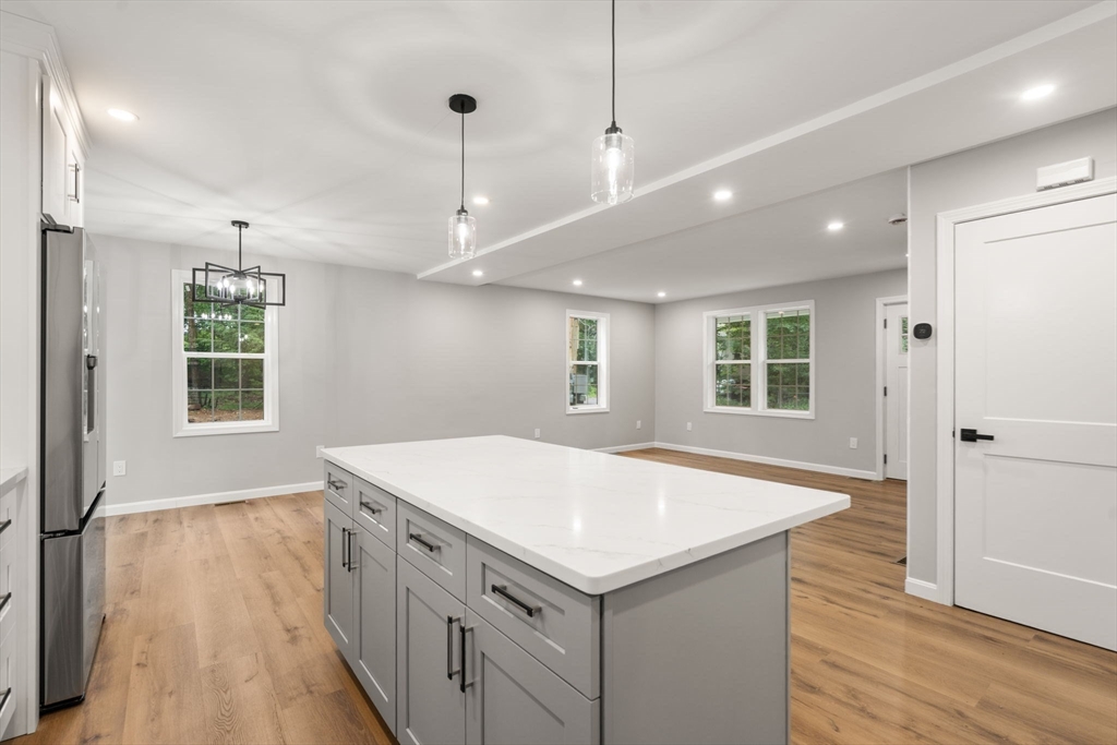 75 Hiland Road Charlton, MA 01507 - Photo 10 of 38 a kitchen with a wooden floor and window