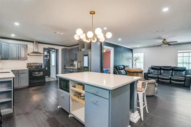 a large kitchen with kitchen island a large island in the center