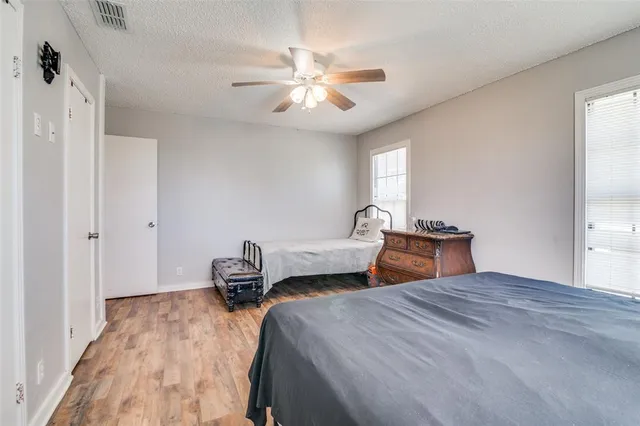 a bedroom with bed and wooden floor