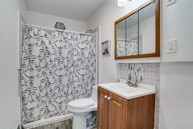 a bathroom with a sink toilet and shower