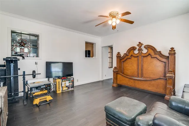 a bedroom with furniture and a chandelier fan