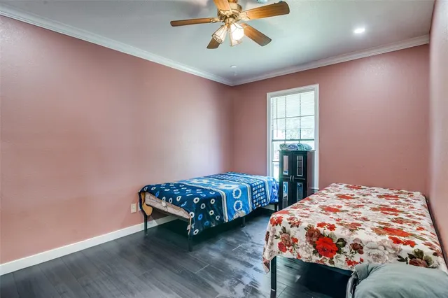 a bedroom with two beds and painting on the wall