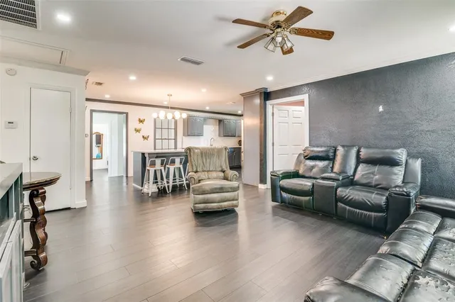 a living room with furniture and wooden floor