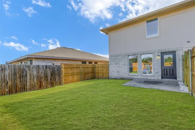 a view of a backyard with a garden and entertaining space