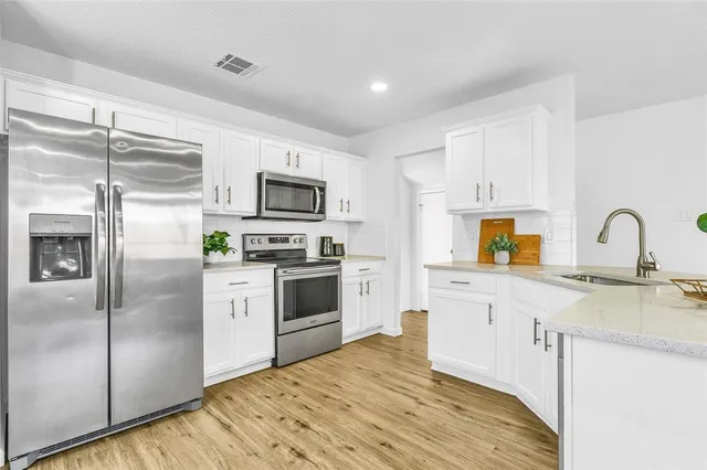 a living room with furniture and a kitchen