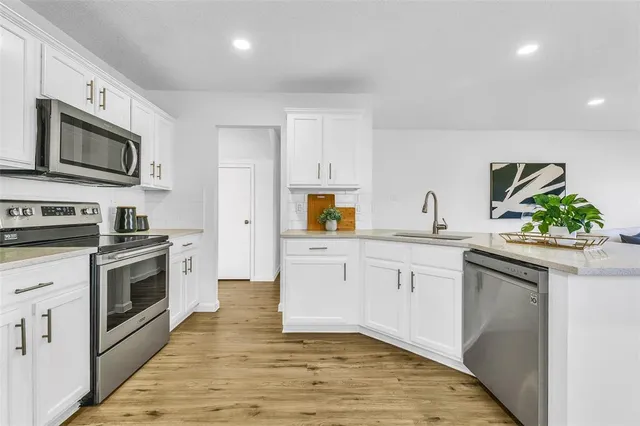 a kitchen with a refrigerator stove and sink