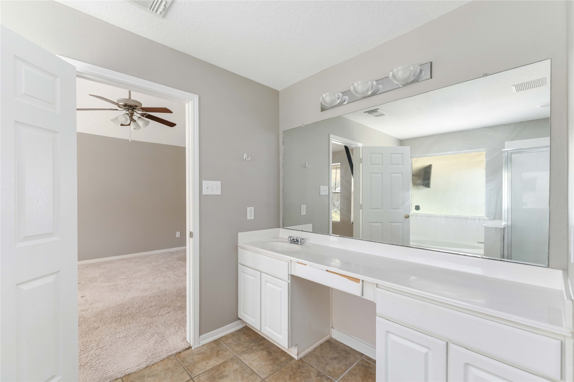 12106 Landsdown Ridge Way Humble, TX 77346 - Photo 13 of 23 a bathroom with a double vanity sink mirror and shower