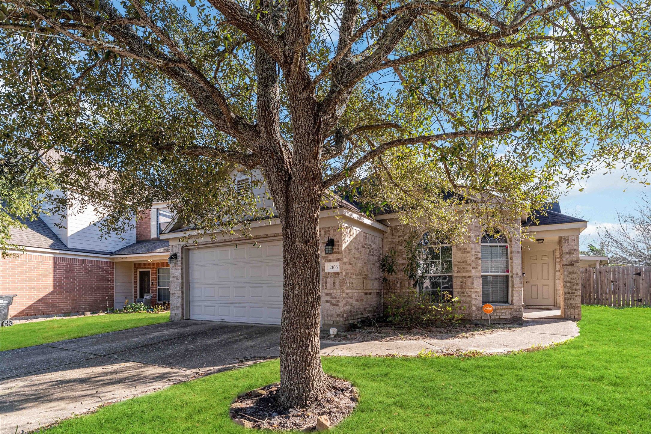 12106 Landsdown Ridge Way Humble, TX 77346 - Photo 2 of 23 a view of a yard in front of a house with a large tree