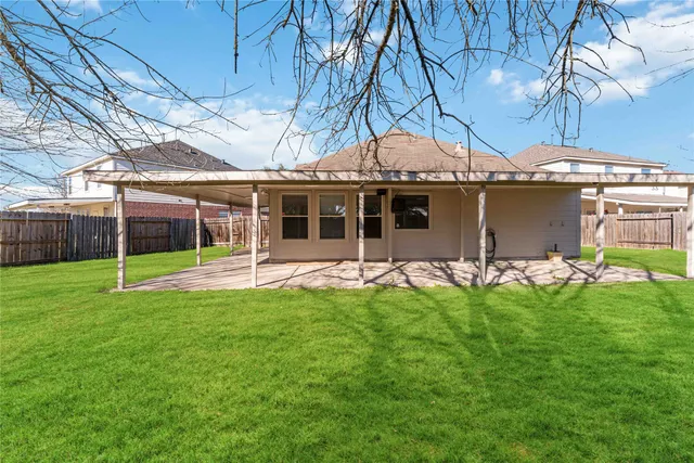 a view of a house with a backyard porch and sitting area