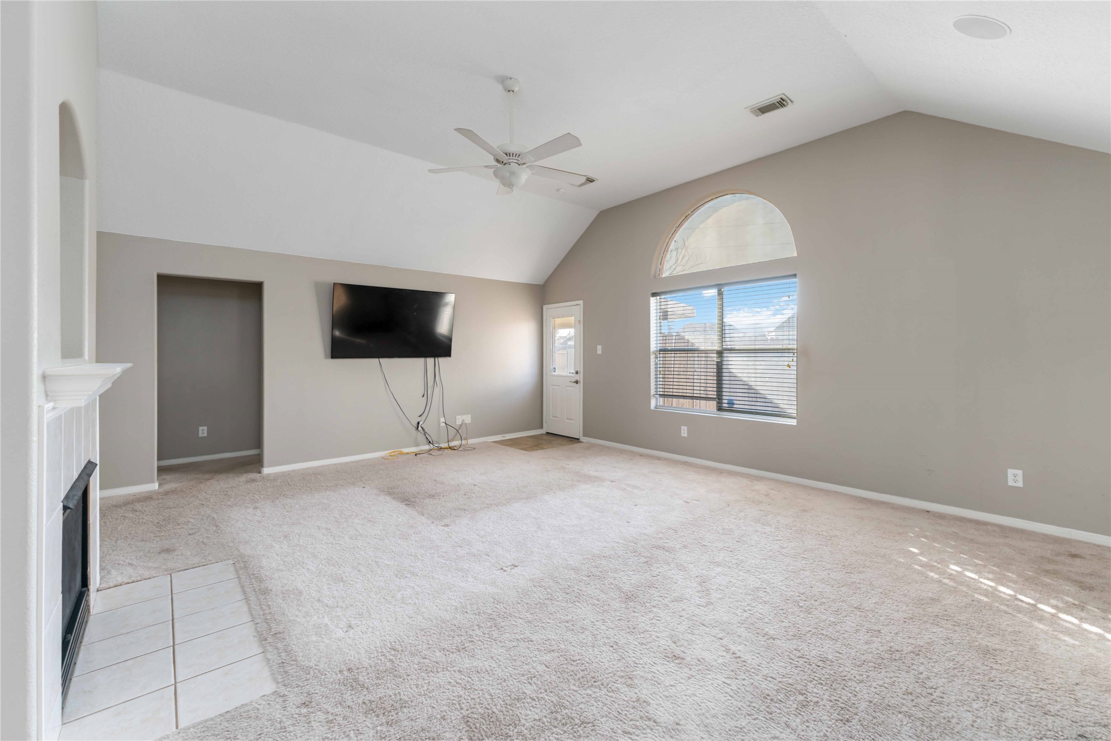 12106 Landsdown Ridge Way Humble, TX 77346 - Photo 5 of 23 an empty room with windows and fireplace