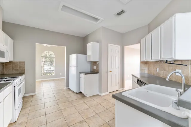 a kitchen with a sink cabinets and appliances