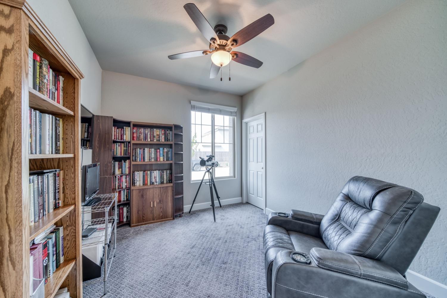 1009 Skylar Lane Clovis, CA 93619 - Photo 12 of 32 a work room with furniture and a book shelf