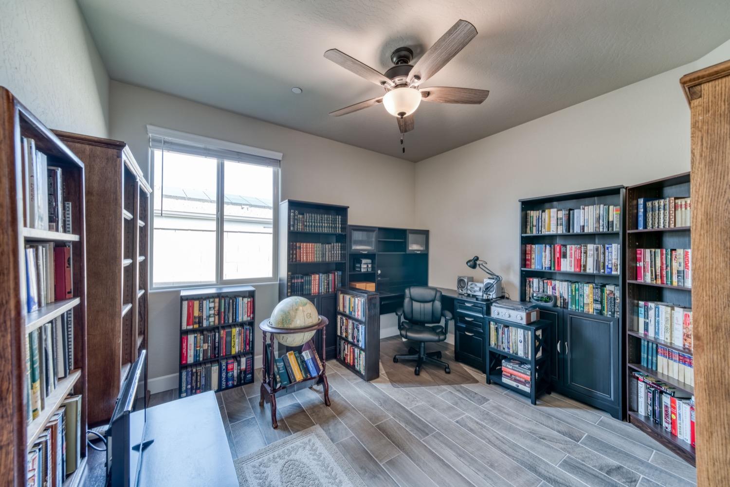 1009 Skylar Lane Clovis, CA 93619 - Photo 15 of 32 a living room with lots of furniture and book shelf