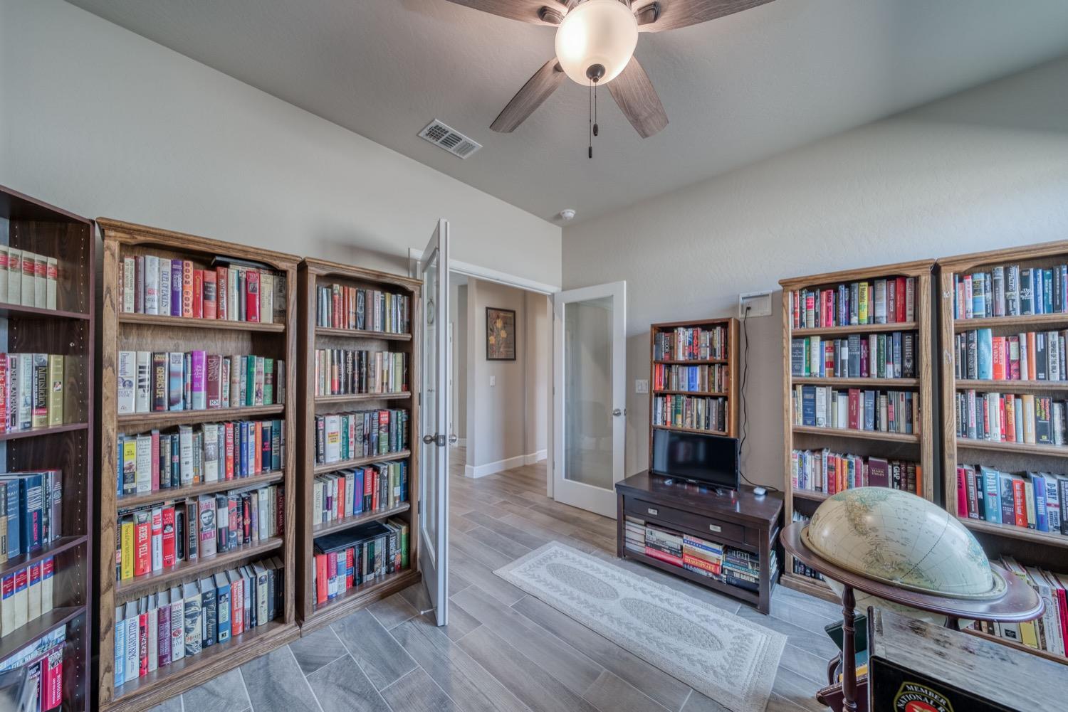 1009 Skylar Lane Clovis, CA 93619 - Photo 16 of 32 a view of a livingroom with a bookshelf and a workspace