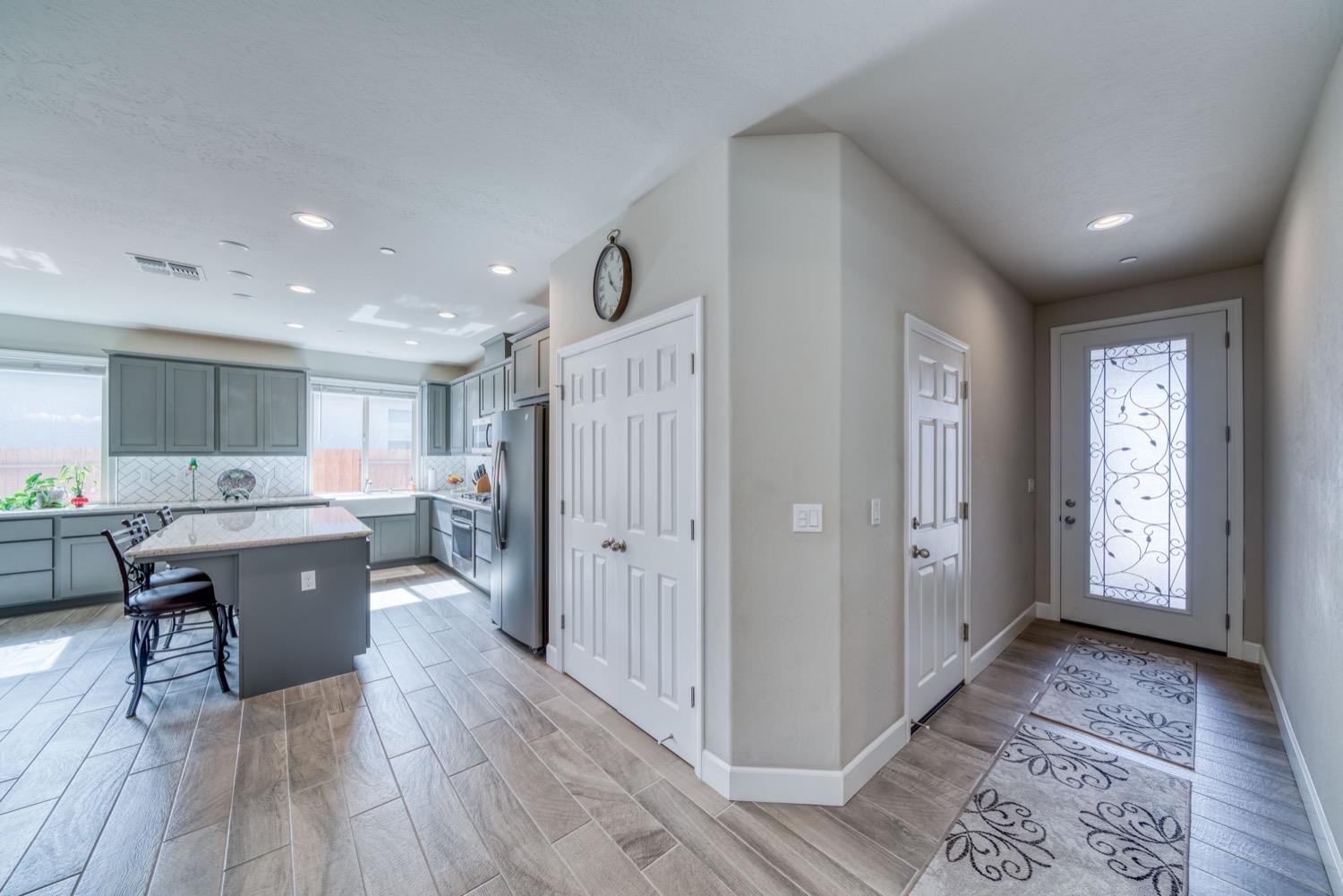 1009 Skylar Lane Clovis, CA 93619 - Photo 2 of 32 a kitchen with a refrigerator a sink and wooden floor