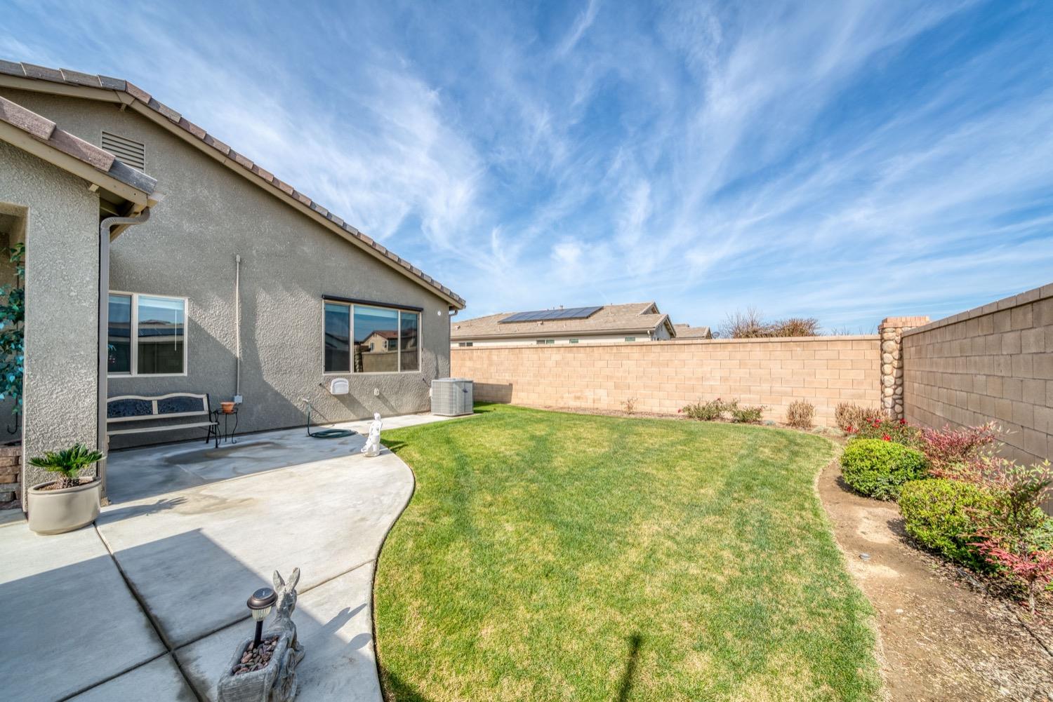1009 Skylar Lane Clovis, CA 93619 - Photo 23 of 32 a view of a backyard with plants and patio
