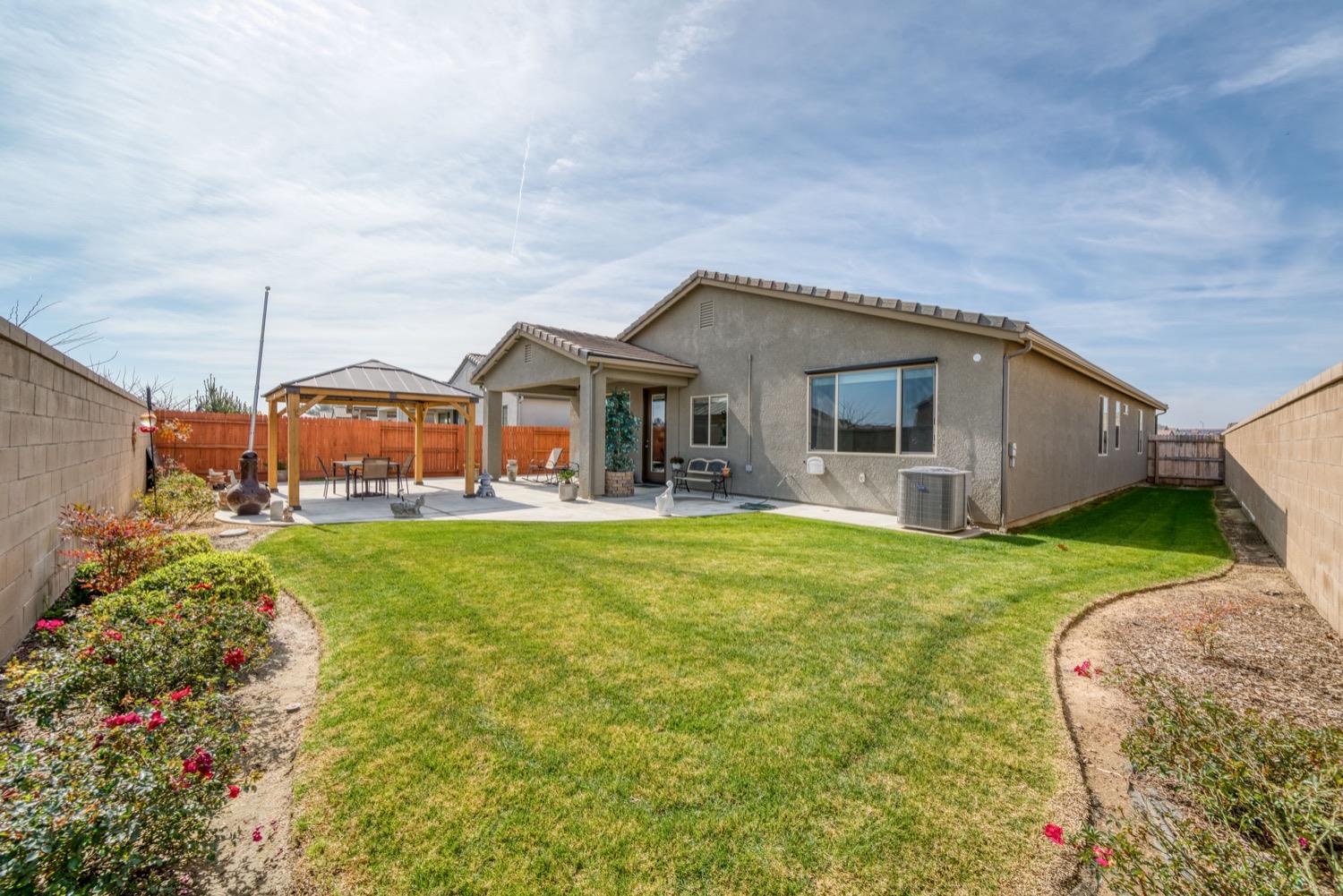 1009 Skylar Lane Clovis, CA 93619 - Photo 24 of 32 a front view of house with yard and green space