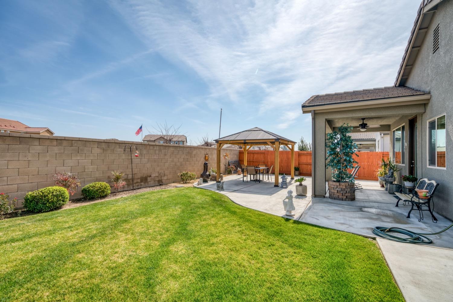 1009 Skylar Lane Clovis, CA 93619 - Photo 25 of 32 a view of a house with backyard porch and sitting area