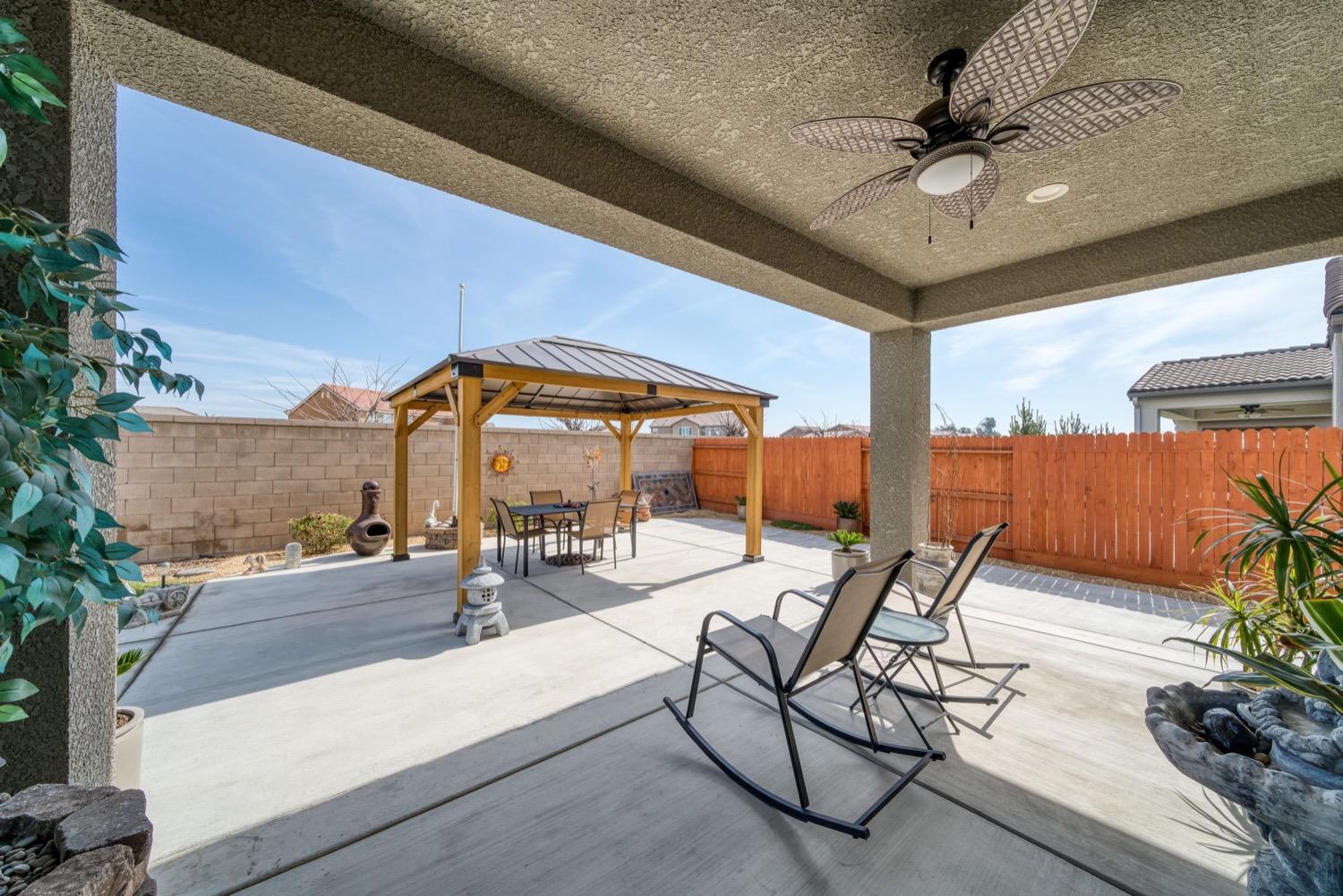 1009 Skylar Lane Clovis, CA 93619 - Photo 27 of 32 a view of a swimming pool with a table and chairs