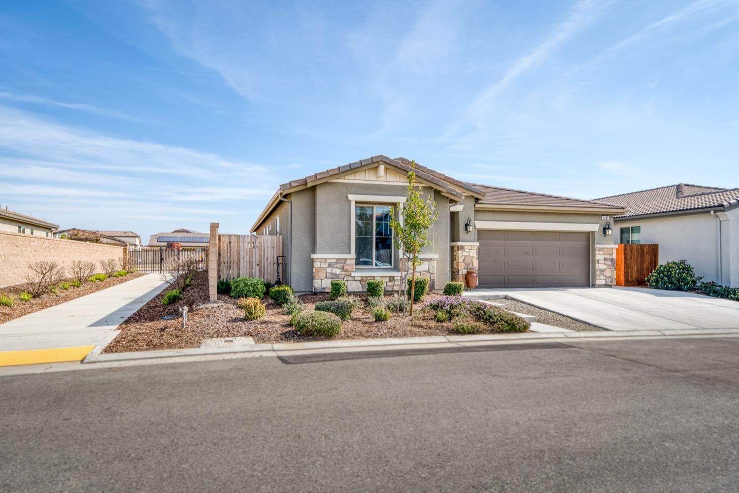 1009 Skylar Lane Clovis, CA 93619 - Photo 29 of 32 a front view of a house with a seating space