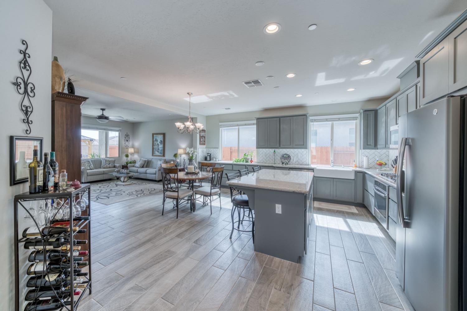 1009 Skylar Lane Clovis, CA 93619 - Photo 3 of 32 a kitchen with a sink a counter top space stainless steel appliances and cabinets