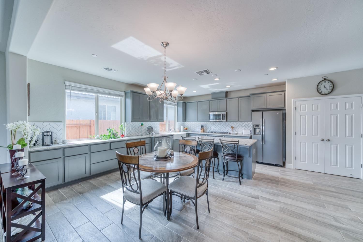 1009 Skylar Lane Clovis, CA 93619 - Photo 4 of 32 a large kitchen with a table and chairs
