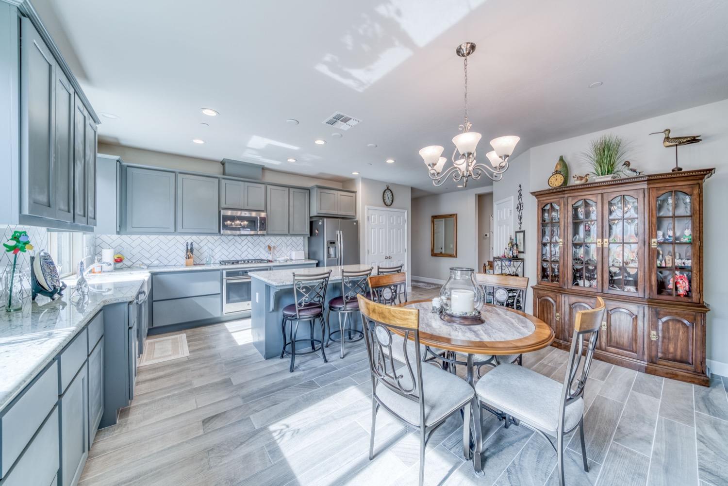 1009 Skylar Lane Clovis, CA 93619 - Photo 6 of 32 a view of a dining room with furniture and wooden floor