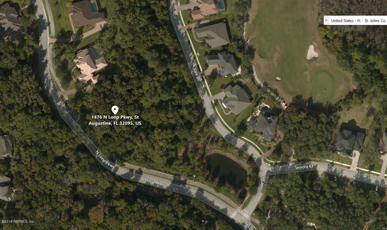 an aerial view of residential house with outdoor space and trees all around