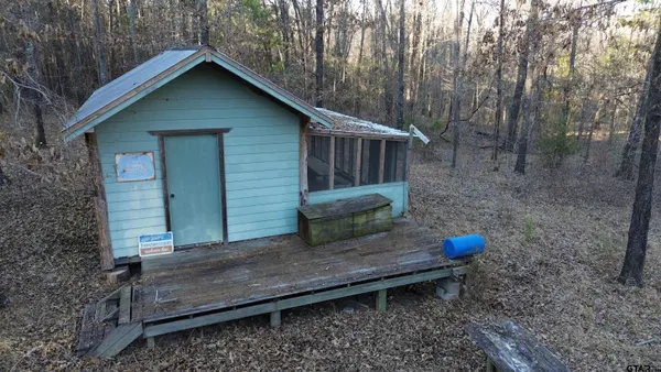 a view of a wooden house with a yard