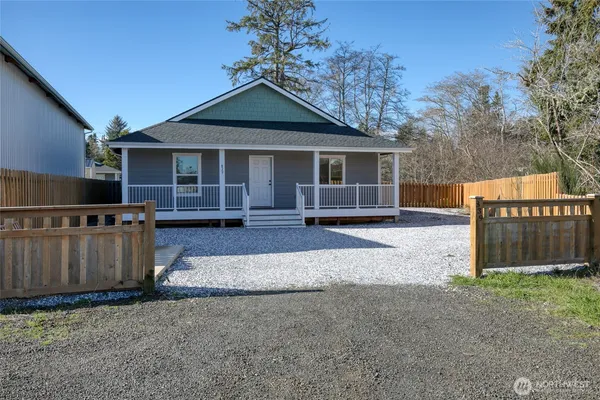 a front view of a house with wooden fence