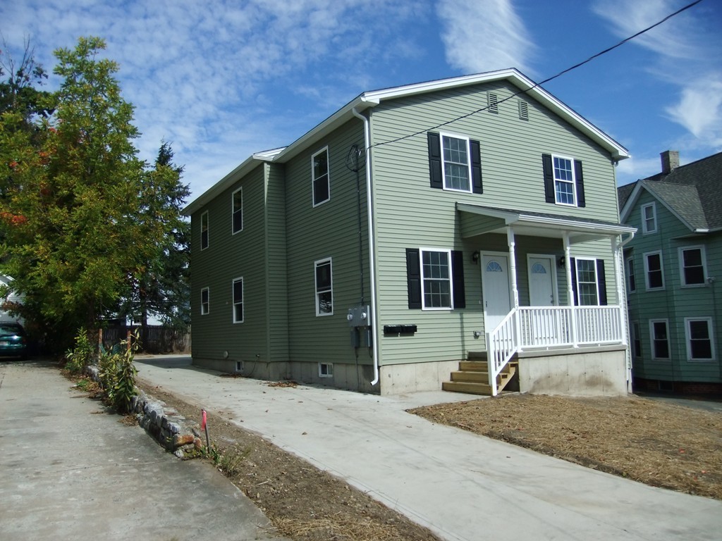 162-164 Corthell Street Springfield, MA 01151 - Photo 2 of 18 a front view of a house with a yard
