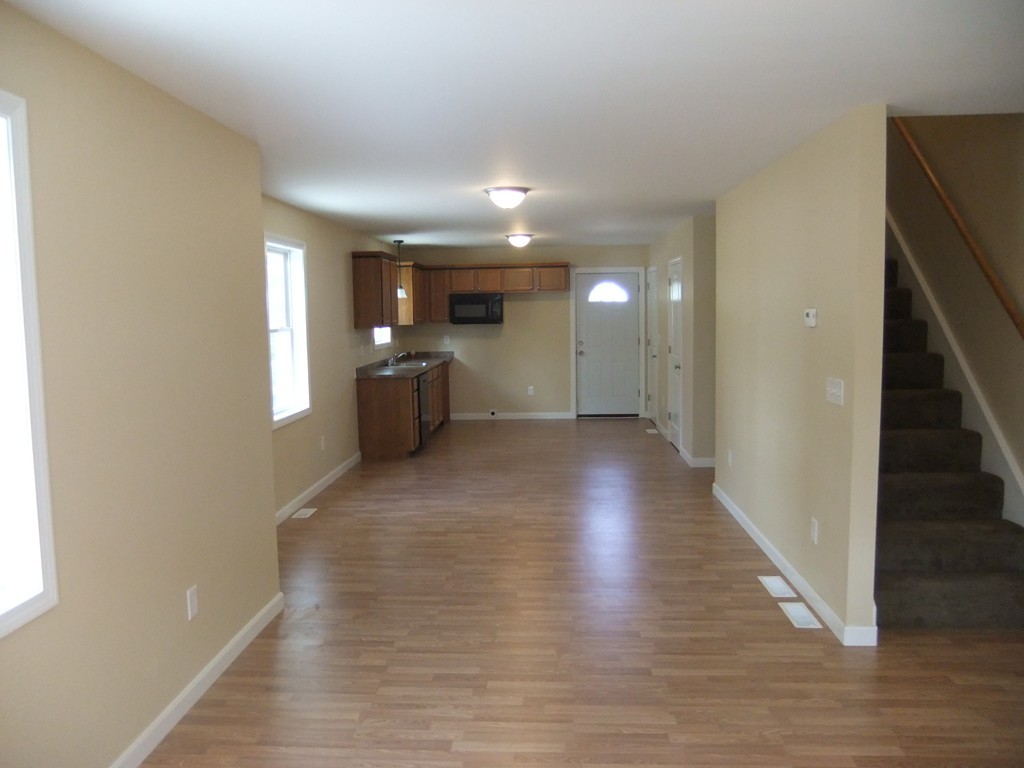 162-164 Corthell Street Springfield, MA 01151 - Photo 3 of 18 a view of a big room with wooden floor and staircase