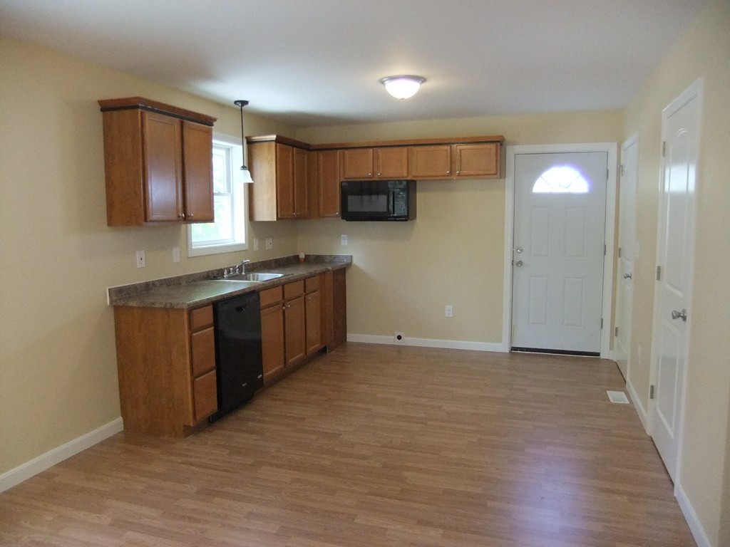 162-164 Corthell Street Springfield, MA 01151 - Photo 8 of 18 a kitchen with stainless steel appliances granite countertop a stove a sink and a refrigerator