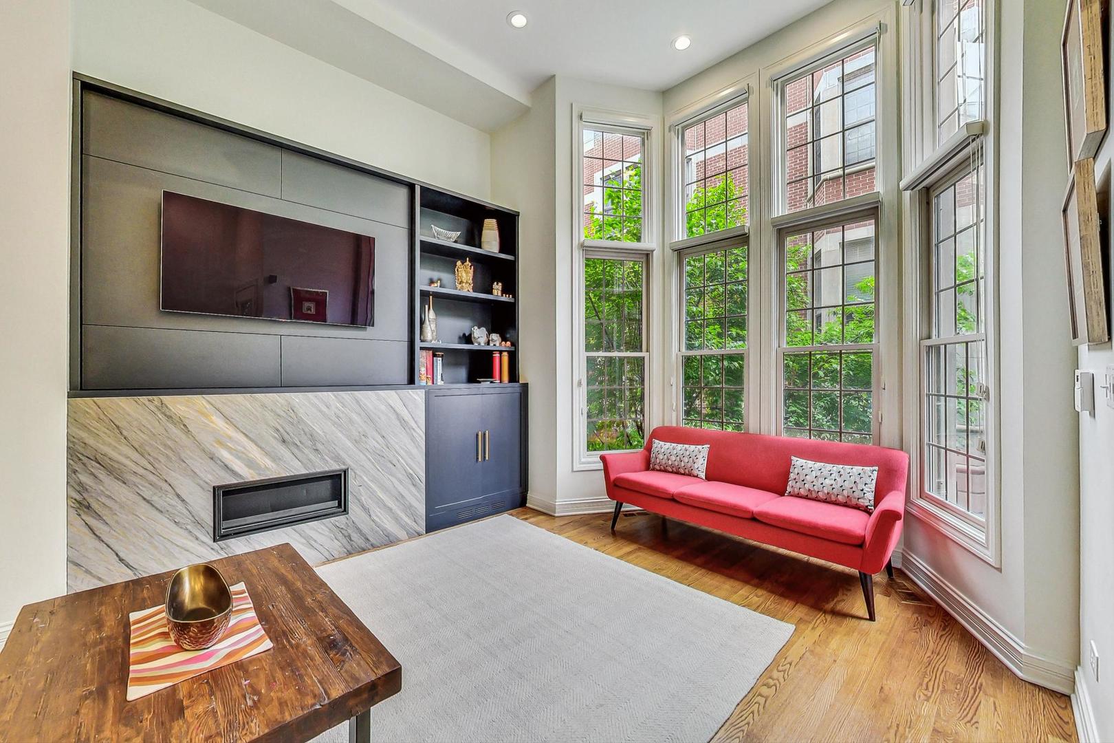 18 North Ada Street, Unit D Chicago, IL 60607 - Photo 12 of 42 a living room with furniture and a large window