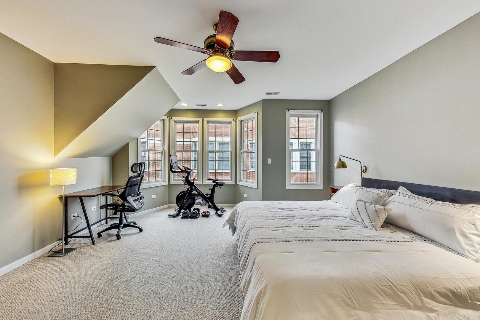 18 North Ada Street, Unit D Chicago, IL 60607 - Photo 21 of 42 a bed room with a bed and a chandelier