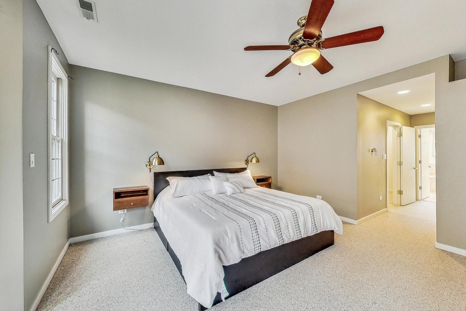 18 North Ada Street, Unit D Chicago, IL 60607 - Photo 22 of 42 a bedroom with a bed and a chandelier