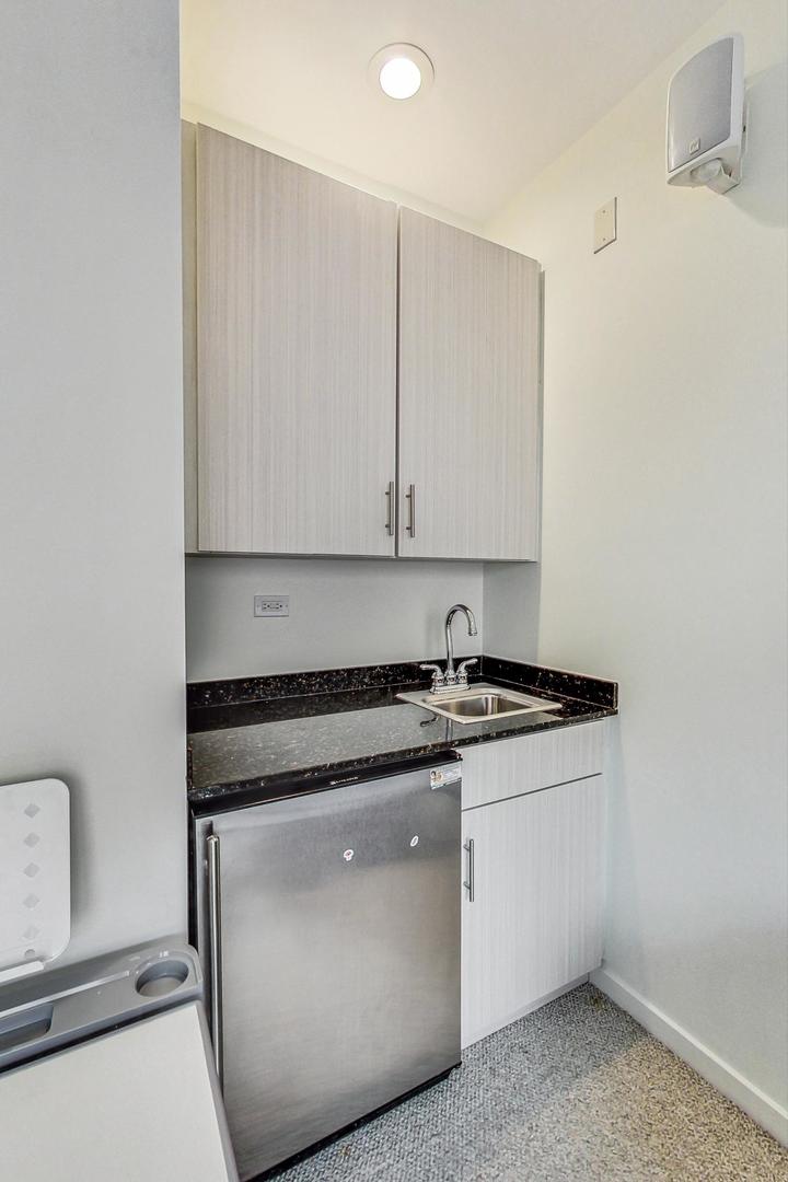 18 North Ada Street, Unit D Chicago, IL 60607 - Photo 32 of 42 a kitchen with stainless steel appliances granite countertop a sink and a stove