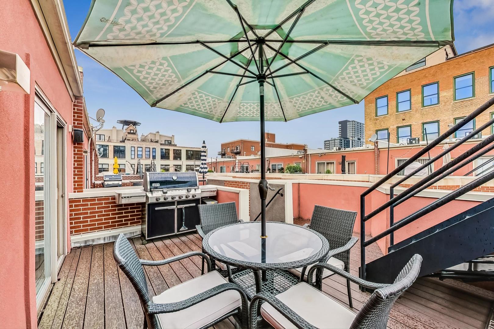 18 North Ada Street, Unit D Chicago, IL 60607 - Photo 38 of 42 a balcony with table and chairs